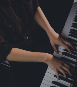 Hands on a piano keyboard